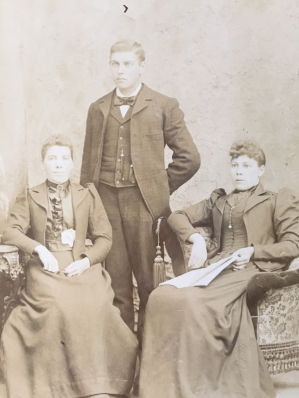 Photo 6: Two seated women and a standing man. Photographer Brockenshire, Beaver Block, Wingham, Ontario.