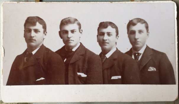 Photo 21: Four men. Photographer and location unknown.