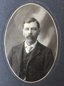 Photo 28: Portrait of a man. Found with album, loose inside cover. Photographer and location unknown.